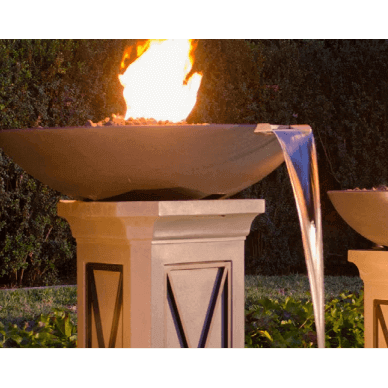 Decorative outdoor fire pit with water feature against a natural background