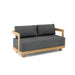 A Granada Deep Seating Loveseat with a gray cushion on a teak wood frame.