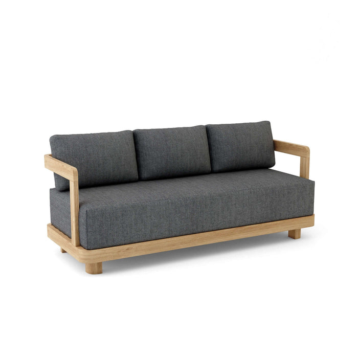 A modern Granada Deep Seating Sofa with a teak wood frame and gray cushions made of All-Weather Sunbrella Fabrics.